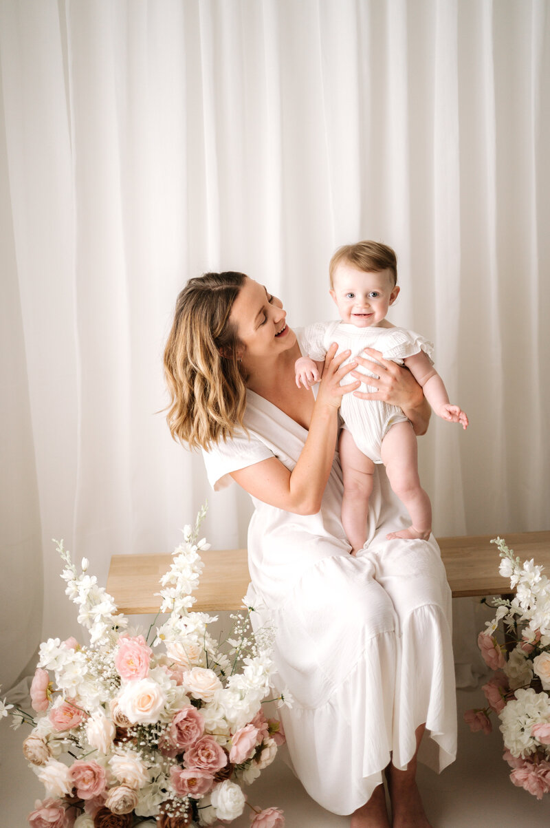 A mother sitting with her little girl at Horsham family photoshoot