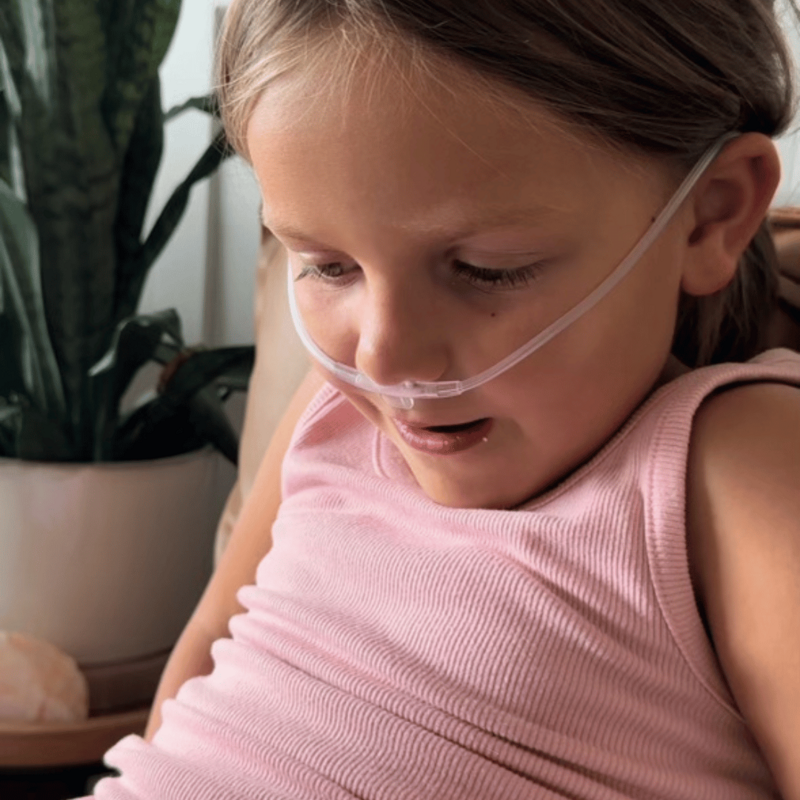 Little girl getting Ozone therapy through nose tubing