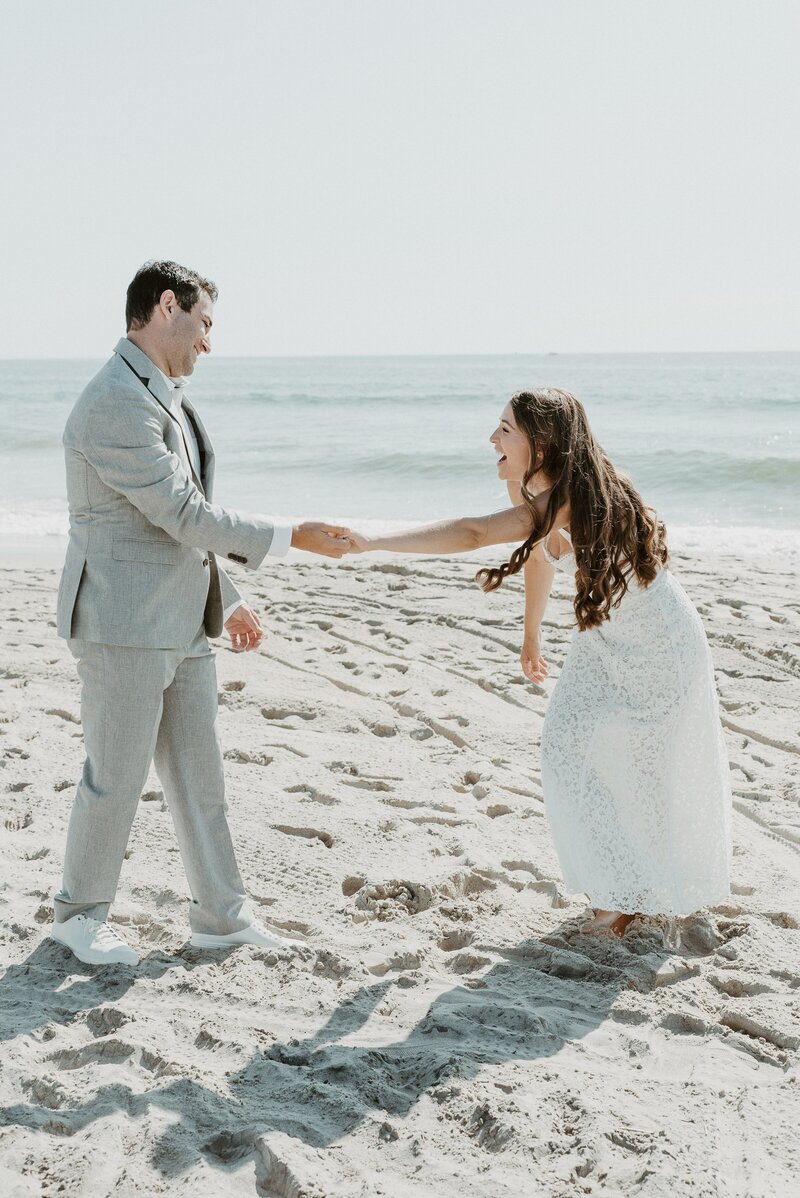 bride and groom dancing on beach in Laguna Beach, CA