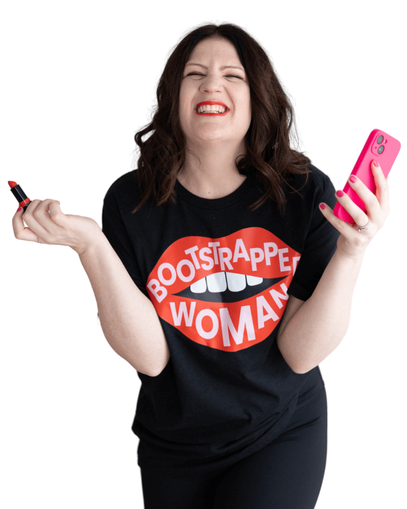 Emily, a brand and web designer, poses with a cell phone in one hand and pink lipstick in the other, radiating confidence.