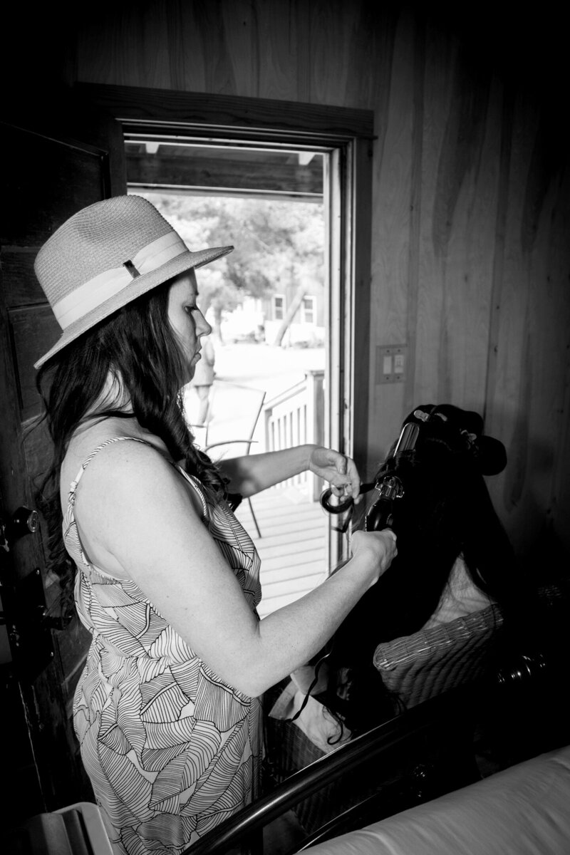 Heidi doing client hair while wearing a hat | Wedding Photography