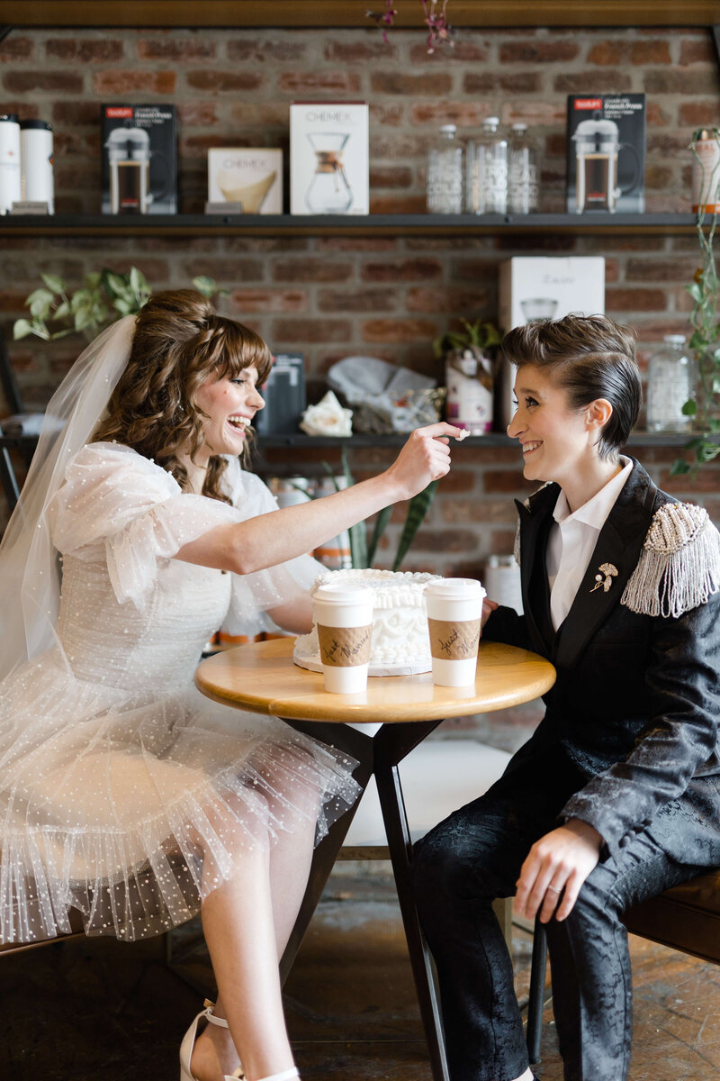 LGBTQ+ wedding couple drinking coffee at cafe