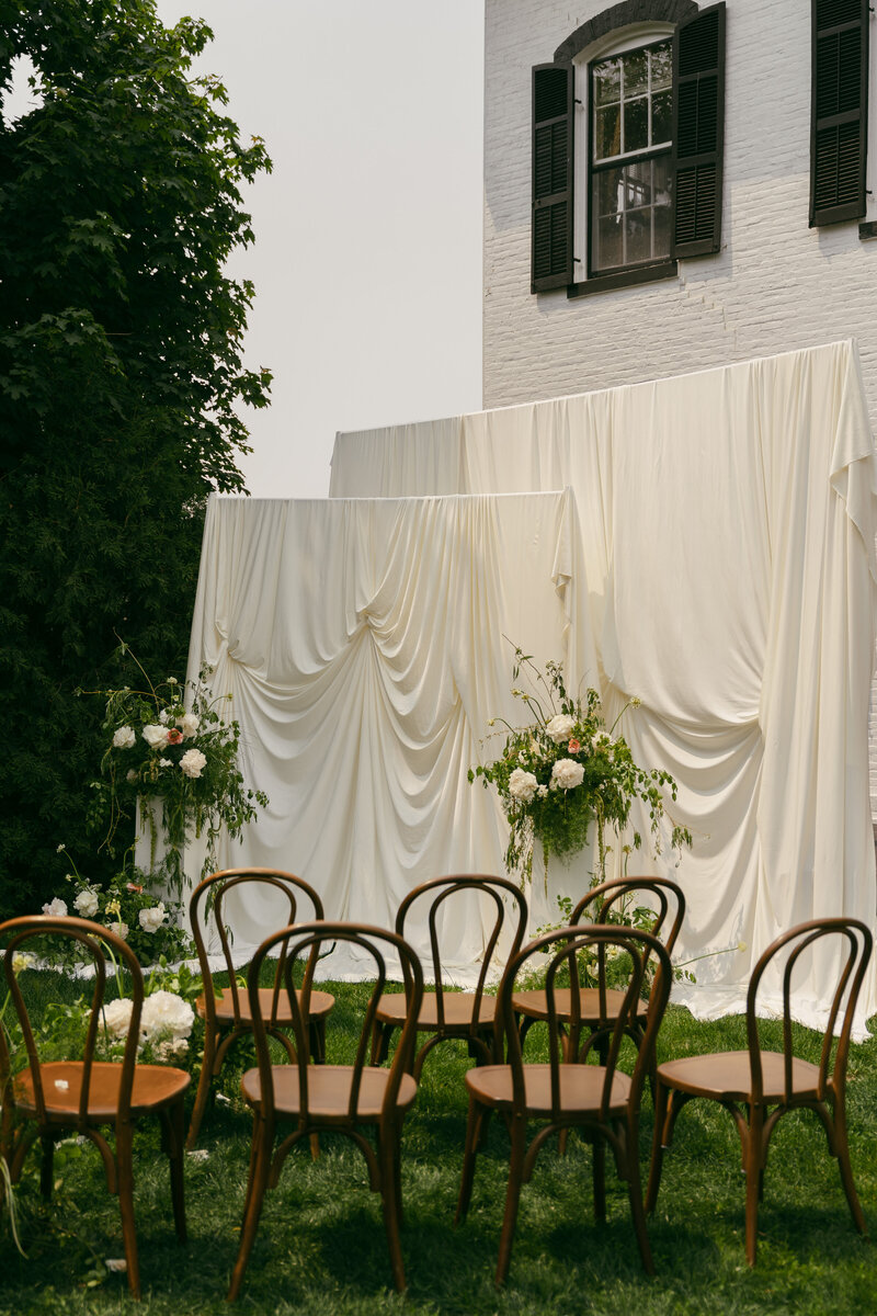 Ceremony draping backdrop setup on wedding day.