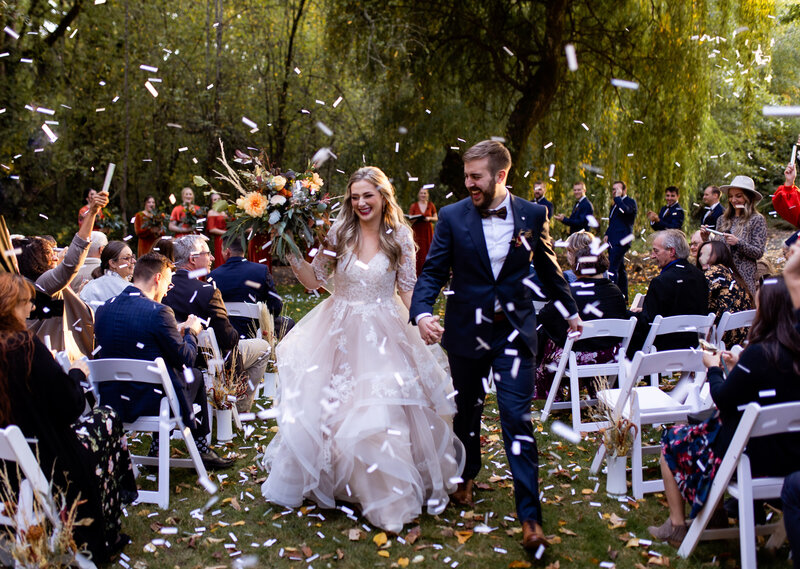 bride and groom leaving outdoor wedding ceremony