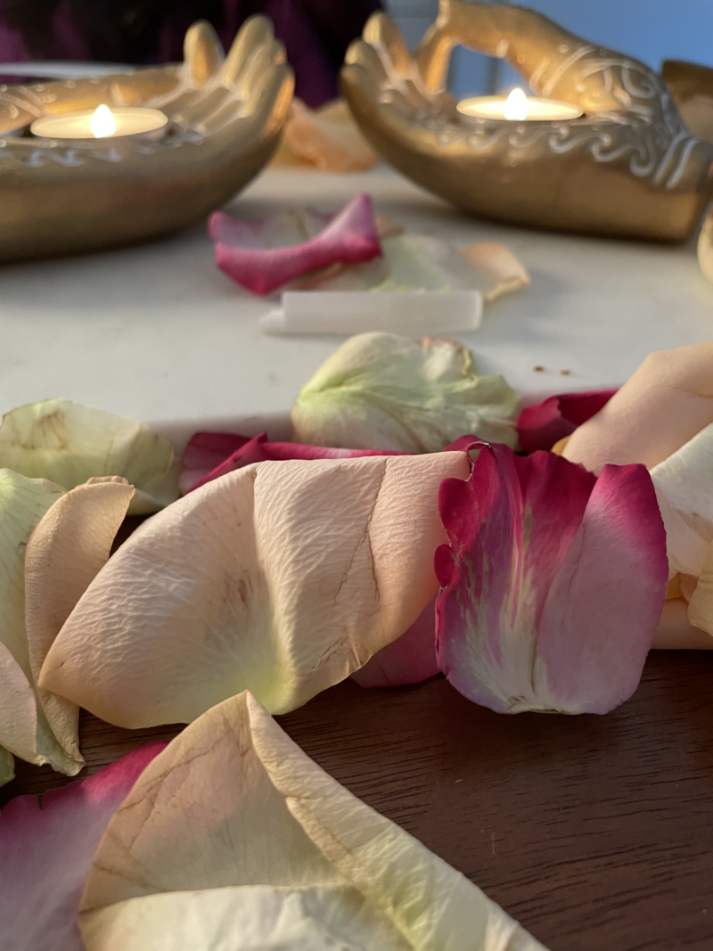 yellow and red flowers laying on a stone surface