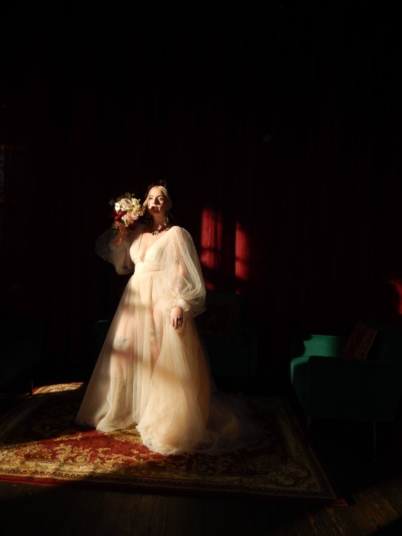 A dramatically lit photo of a bride