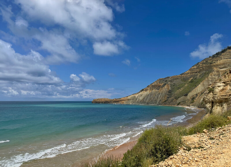 Uncrowded beach with golden cliffs and bright blue skies in the Dominican Republic