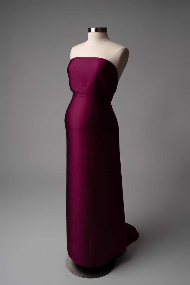Magenta two-piece maternity fabric wrapped on mannequin