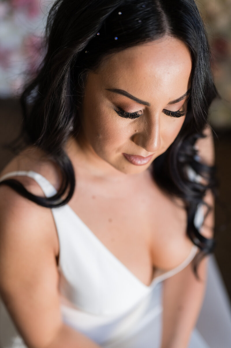 Bride getting ready at Emerald at Queensridge, wearing ‘The Archie’ gown from Love and Lace Bridal Salon.