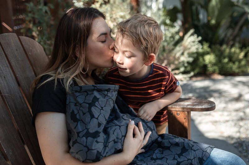 Woman with toddler and breastfeeding infant