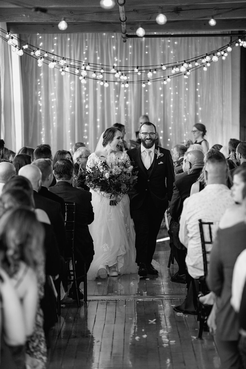 bride-groom-walking-down-aisle-smiling