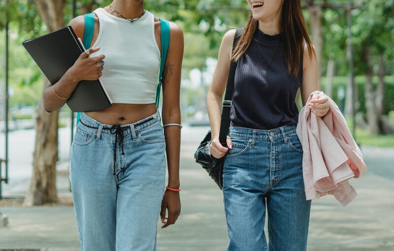 Two teen girls talking and walking; Zen Chung Pexels