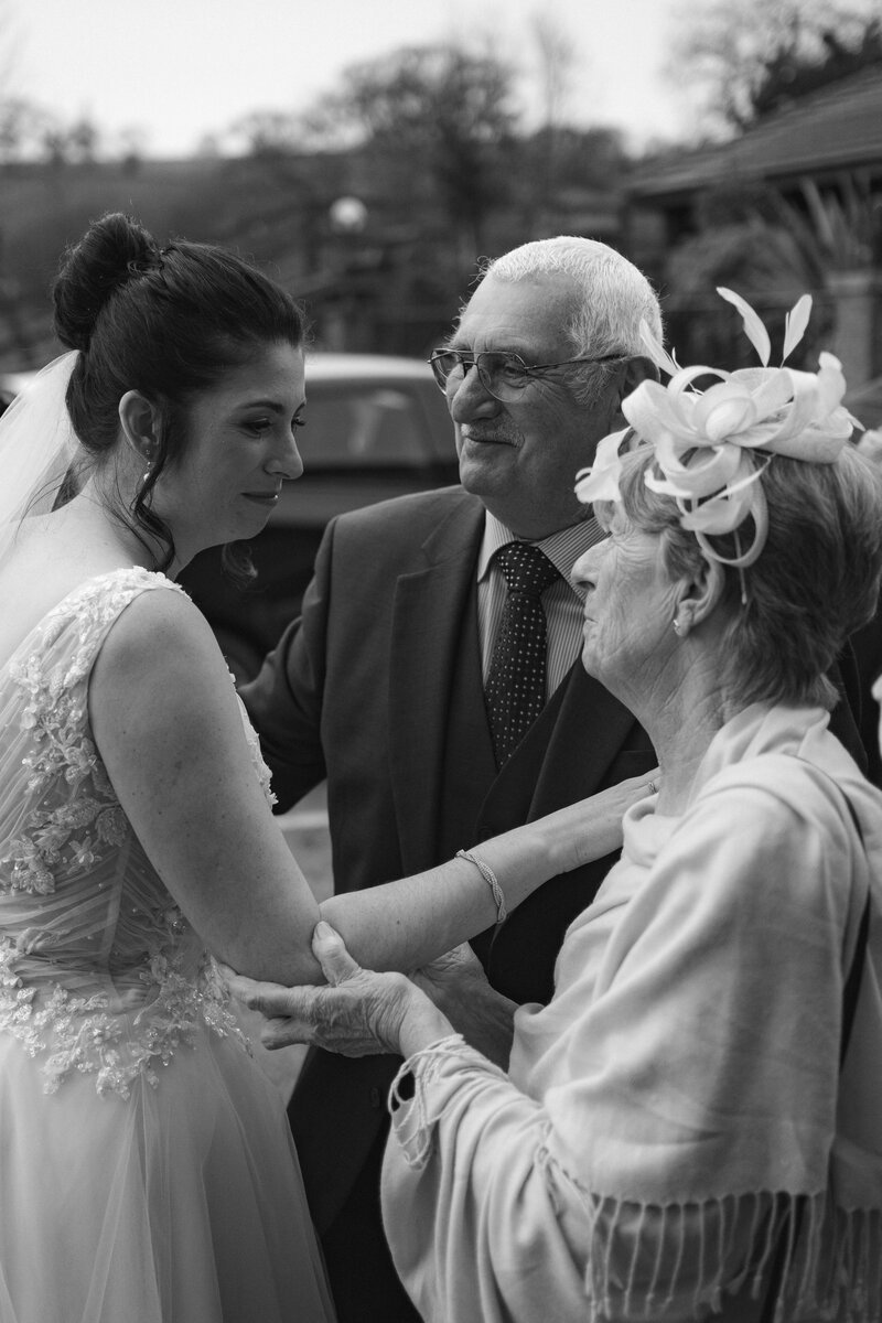 close up of bride greeting grandparents
