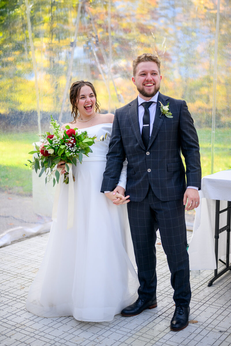 Husband and wife newlyweds laughing at the speeches in Owen Sound, Ontario