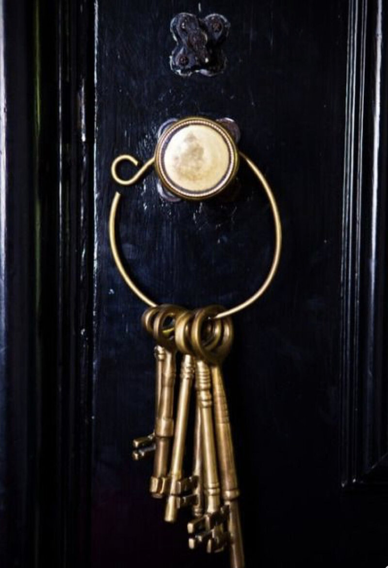 gold keys hanging from black door