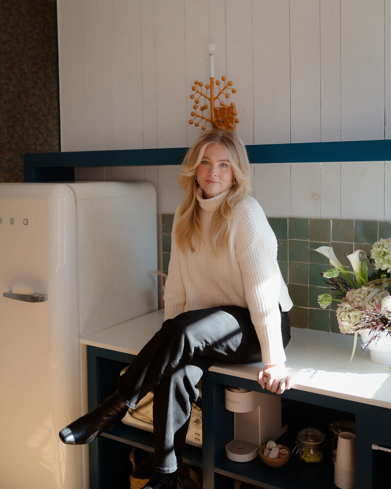 Sara sitting on a luggage cart at Hotel Havana