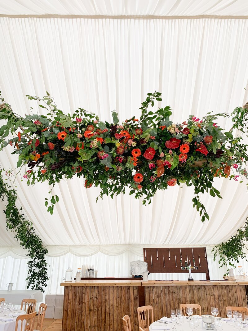 Hanging display of flowers in a marquee