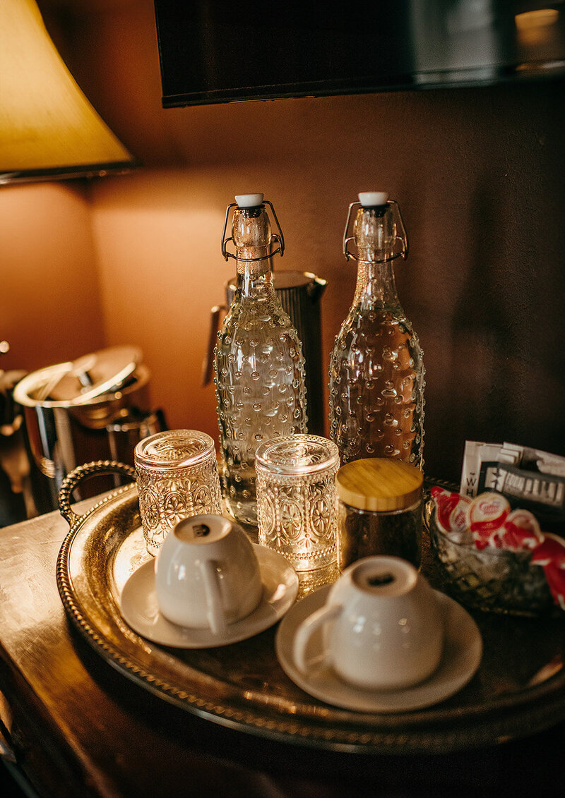 Elegant glassware sits atop a tray waiting for you
