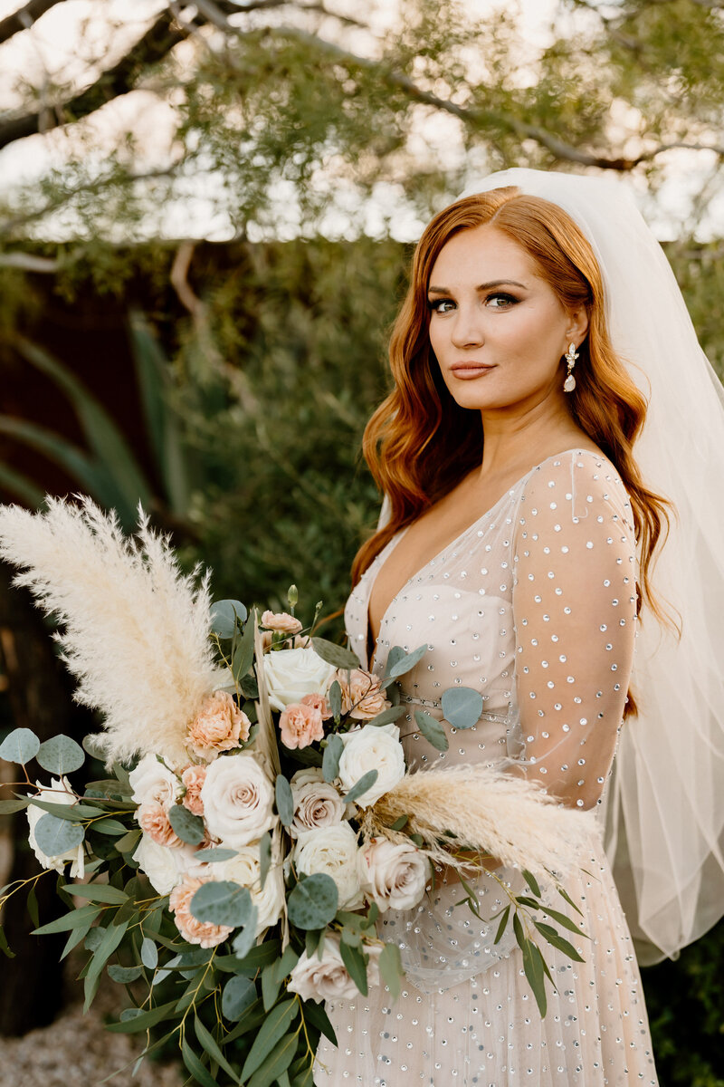 bride poses with bouquet