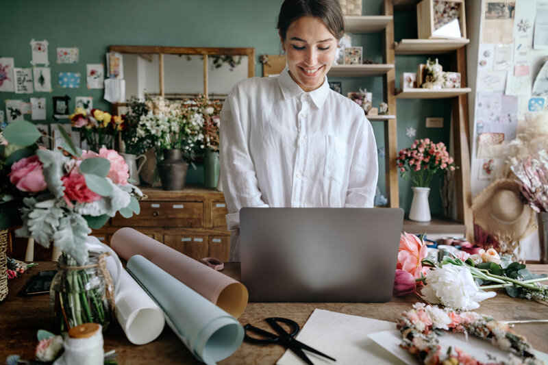 Smiling woman while watching on her laptop