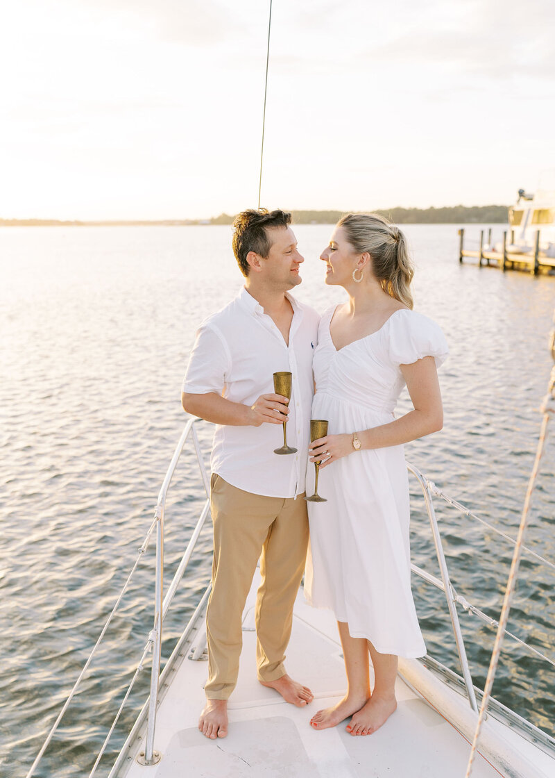 engaged couple toasting on a boat