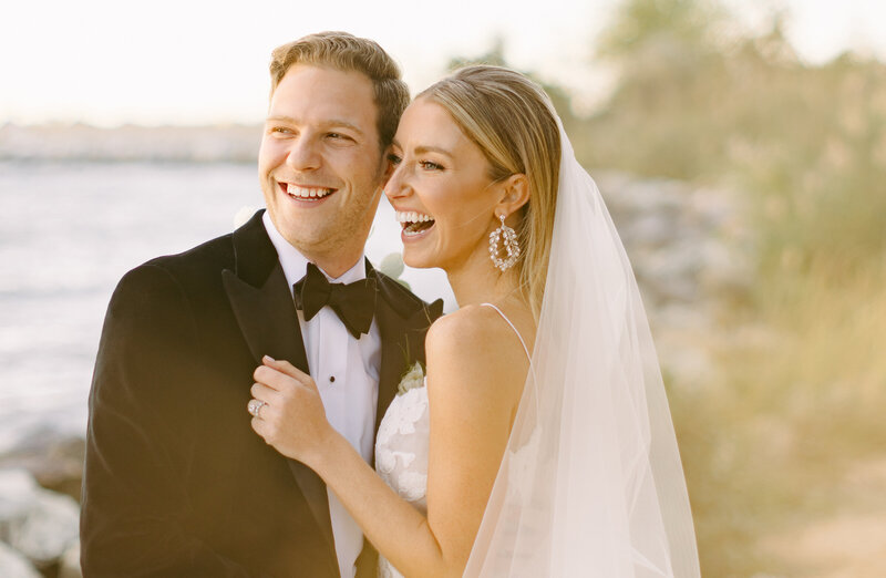 Newlyweds laugh during their golden hour portraits