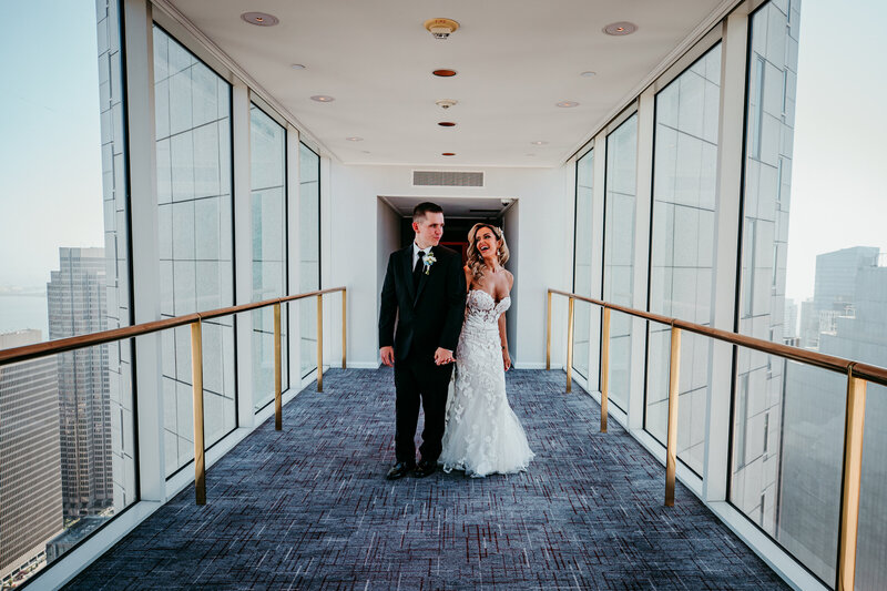 Bride and groom walking through the hallway at the Four Seasons San Francisco at Embarcadero, captured by San Francisco elopement photographer Kristin Smith.
