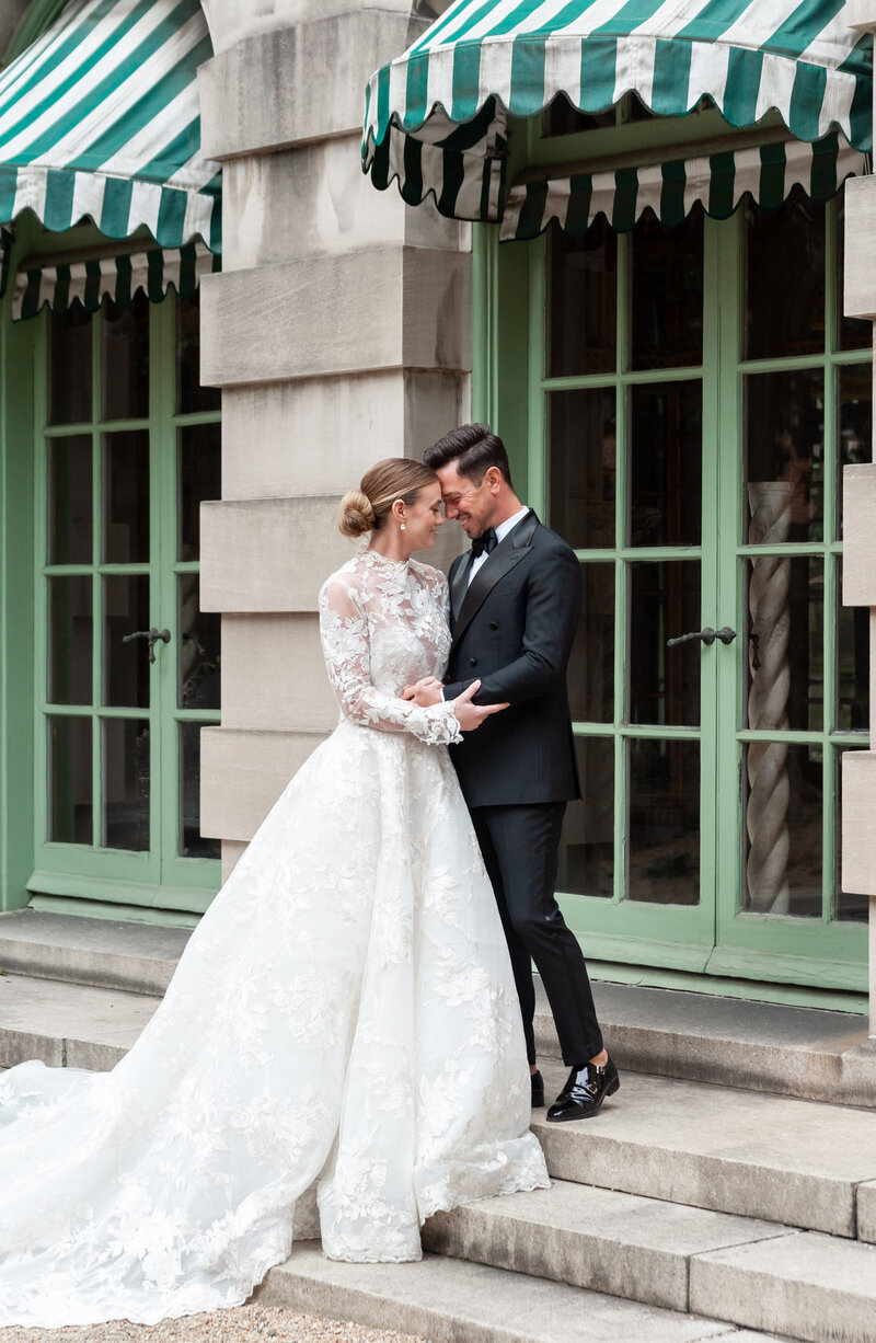 bride and groom embracing on the terrace of the Anderson House in DC