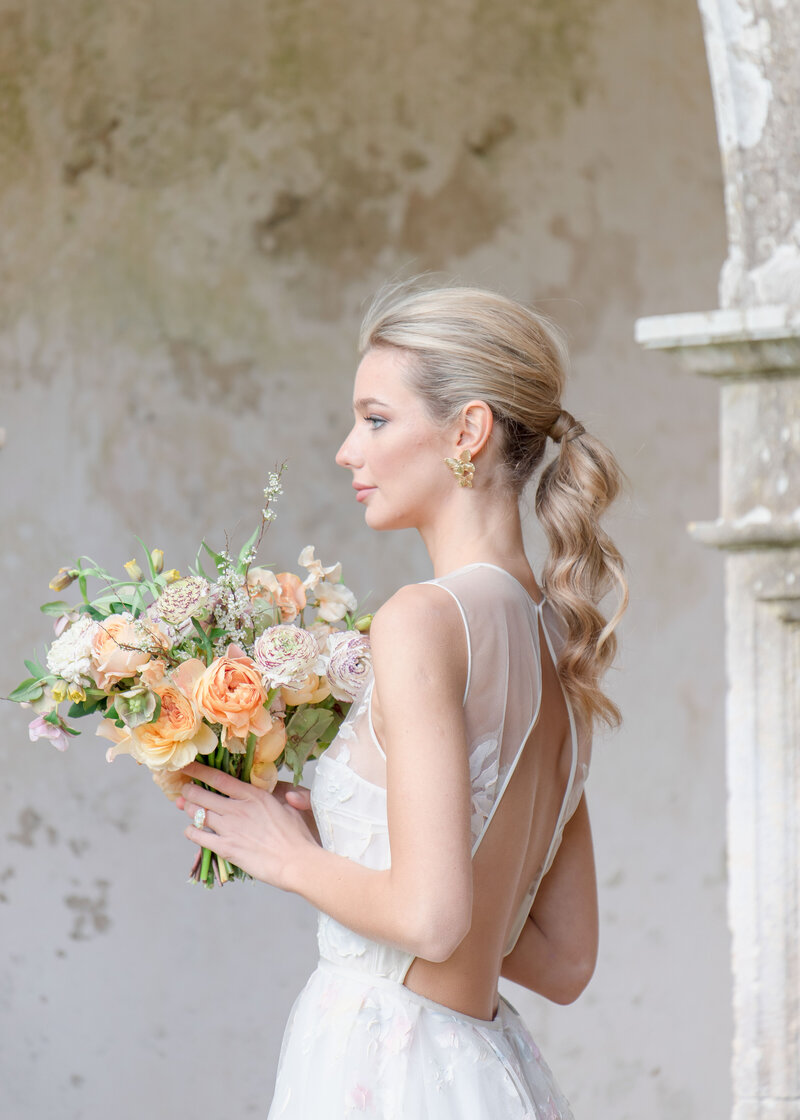 bridal portrait of bride in front of stone wall at puglia wedding