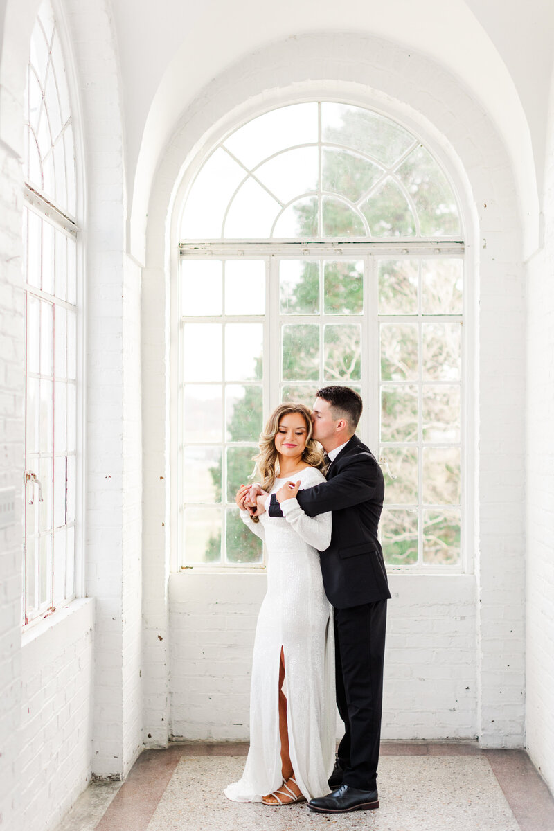 an engaged couple in black and white formal wear