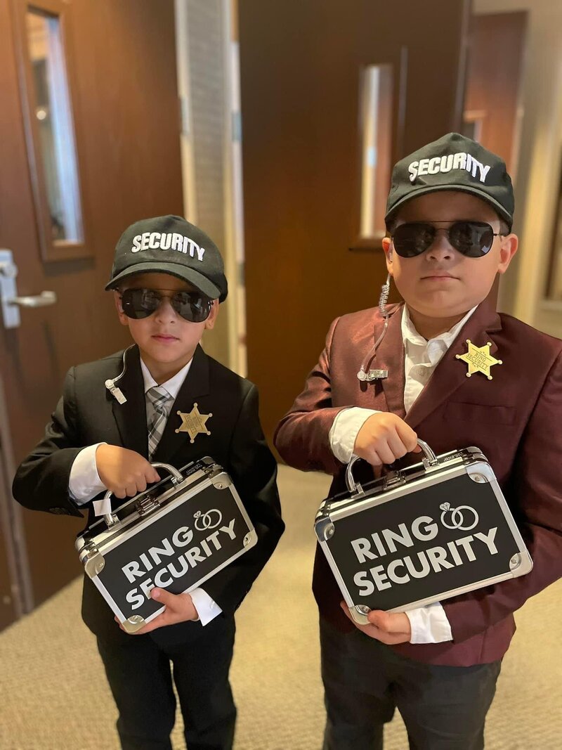 ring security guards holding ring boxes