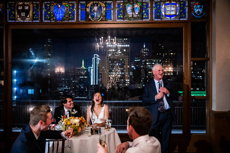 Wedding reception toast at University Club San Francisco with city skyline views - wedding photographer