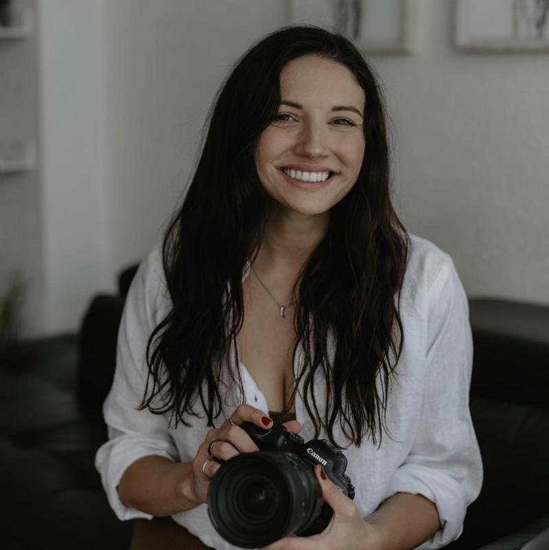 photographer smiling while holding camera