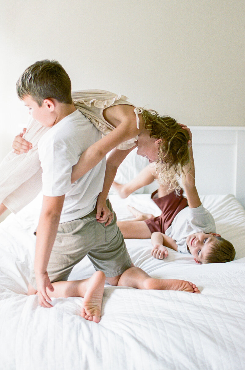 kids playing on bed from  beginner photography course for moms