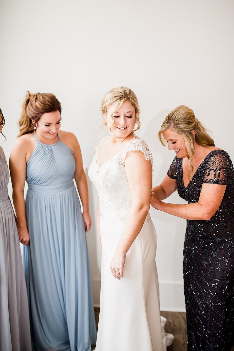 zipping the dress by Knoxville Wedding Photographer, Amanda May Photos