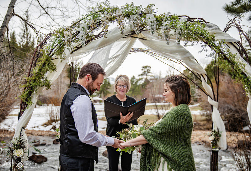 Couple Exchange Rings riverside at Romantic Riversong Inn Estes Park CO