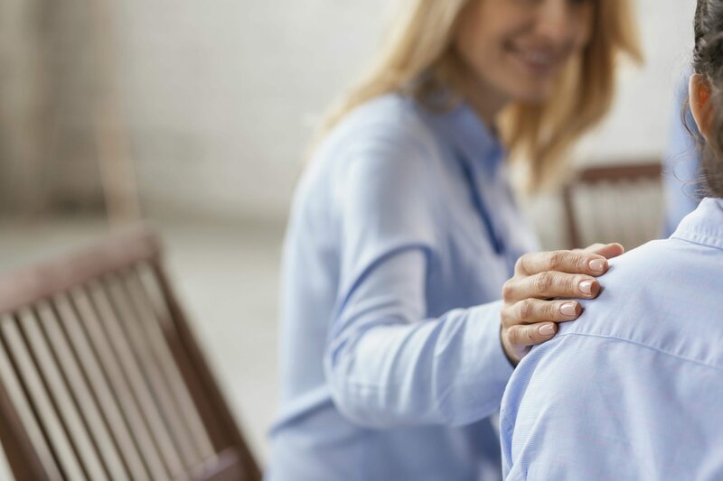 A close up picture of two people in a therapy session