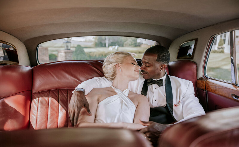 man-and-woman-cuddling-in-back-seat-of-bentley