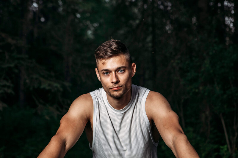 muscular man on bike looks directly at camera
