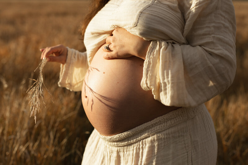 A maternity photograph of a woman during golden hour in Jackson, Wyoming.