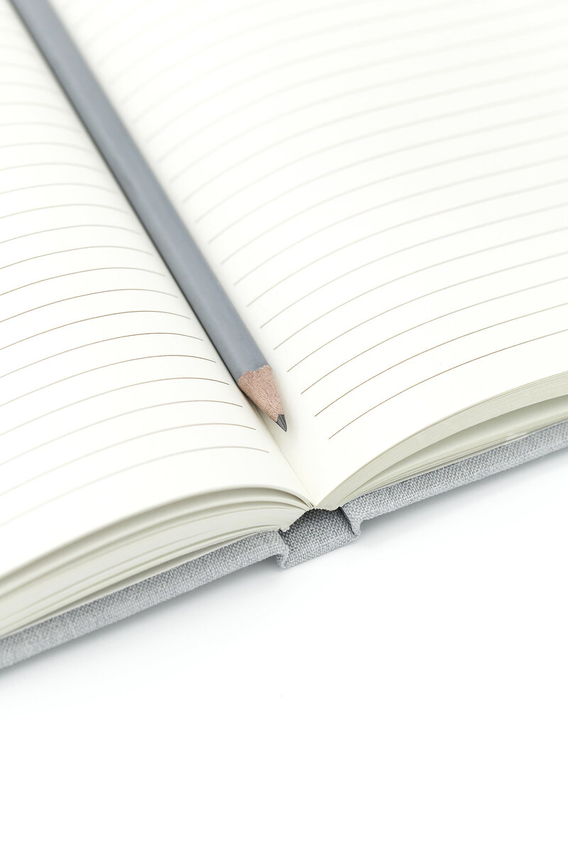 An open notebook and a pencil, the copywriter translator tool.