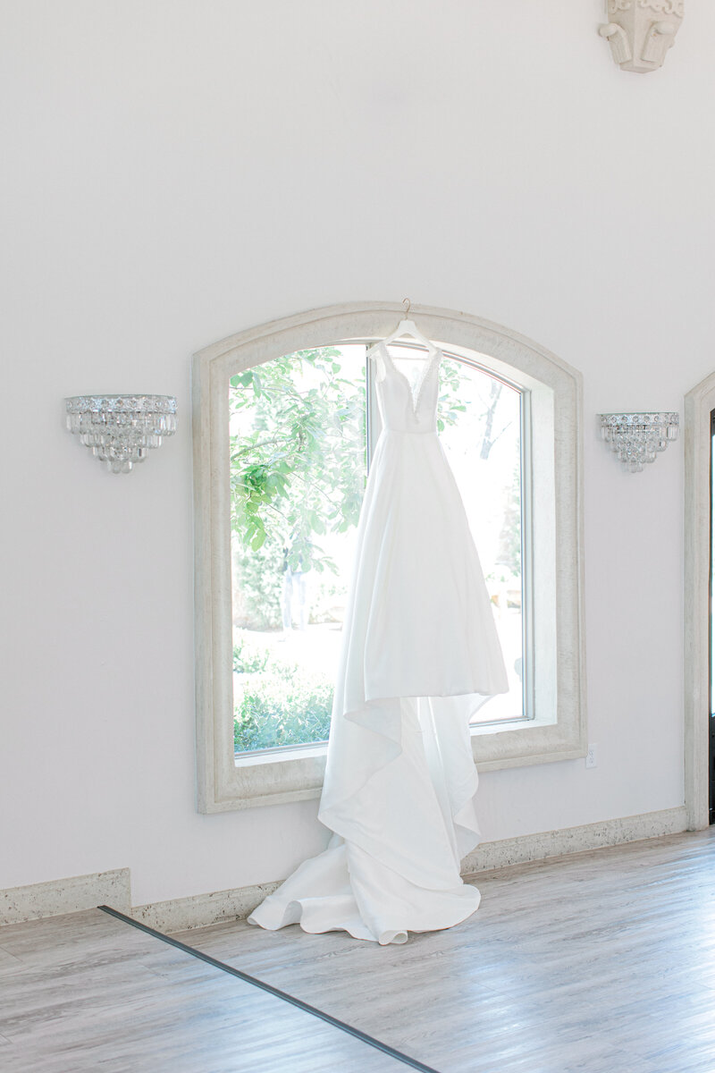 Swank Soiree Dallas Wedding Planner Kelci and CJ Knotting Hill Place - Wedding dress in a window