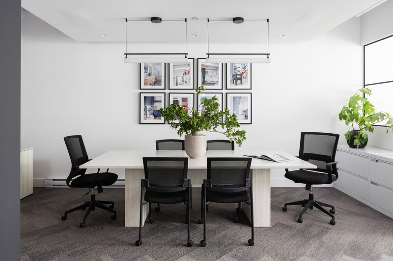 Ashley de Boer interiors creates a stylish meeting room with modern design elements.