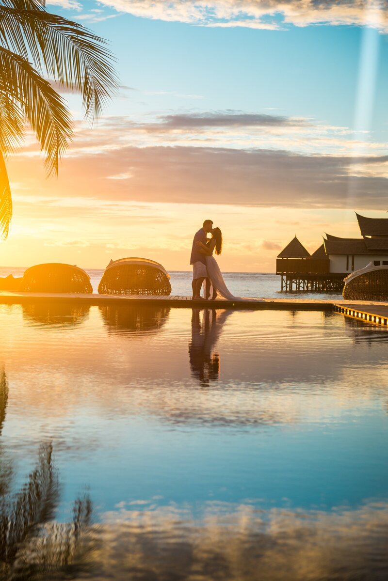 Couple kissing under sunset in a beach resort