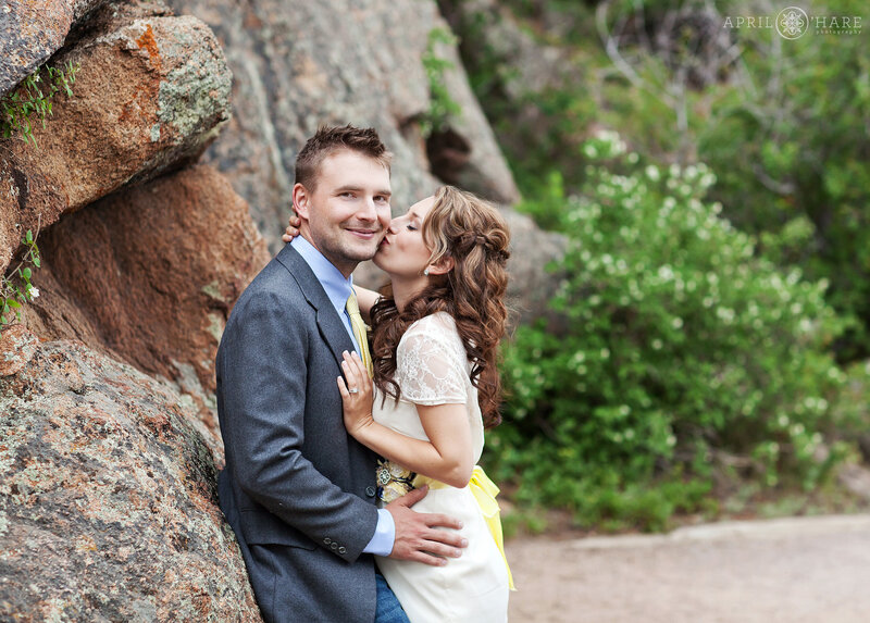 Cute couple kiss on the path at Lily Lake in Estes Park's Rocky Mountain National Park