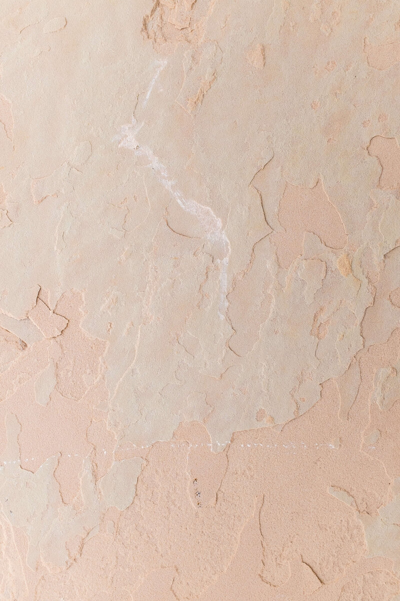 Finish sample of a rustic plaster wall finish in a warm peachy tone