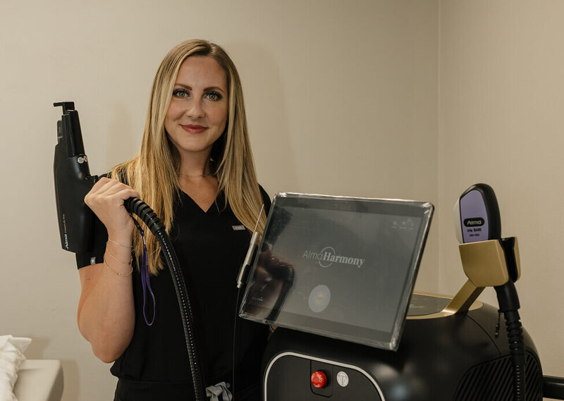 Kylee Johnson, founder of RMWC, showing off their laser machine at the clinic.