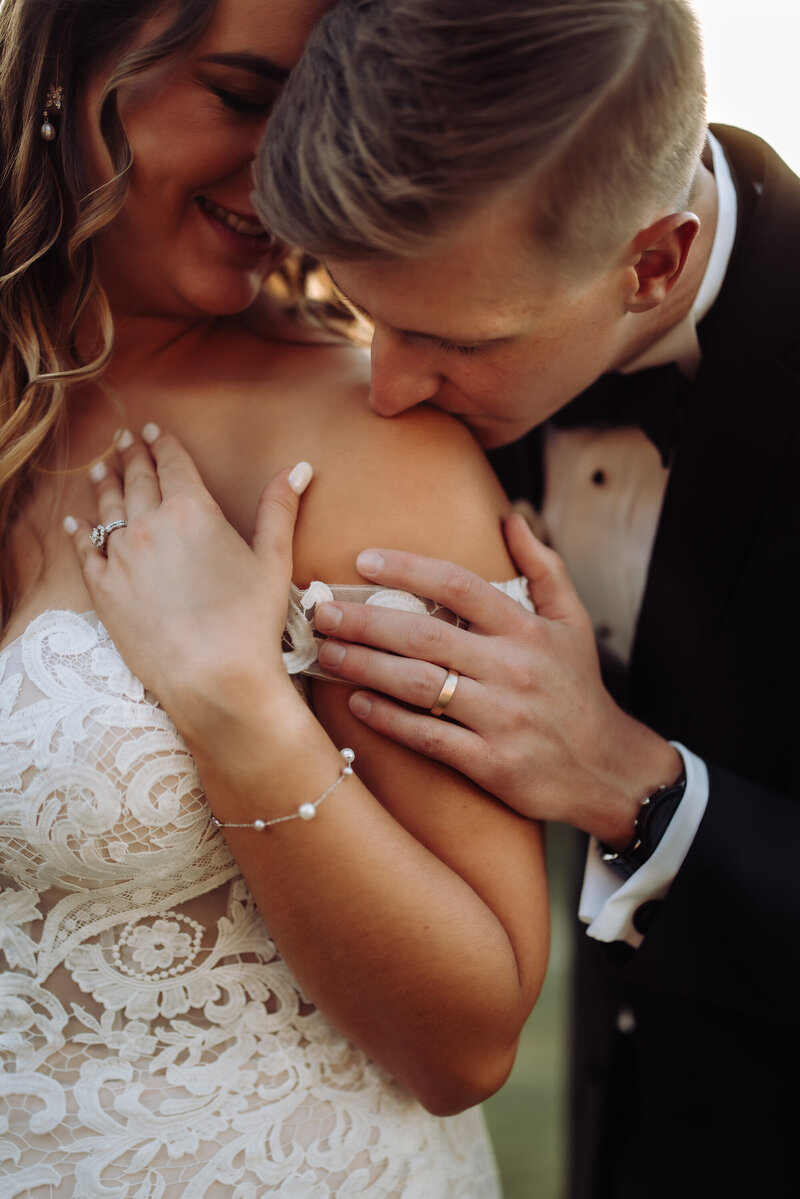 groom-kissing-brides-shoulder