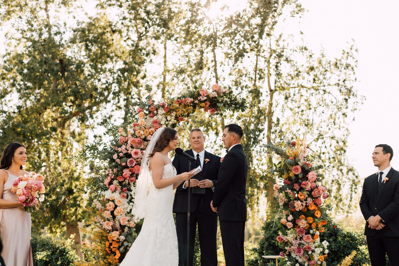 Bride and Groom kissing on gold course in Scottsdale, Arizona captured by a Scottsdale wedding photographer in a scenic outdoor wedding venue.