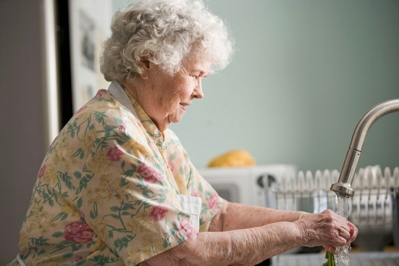 Older woman doing the dishes